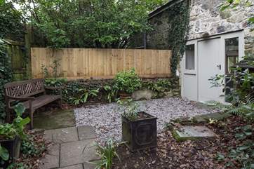 At the top of the pathway, the front door is privately tucked away and well lit.