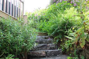 The barn is accessed via a gradually sloping pathway and flight of stone steps to the left of the picture.