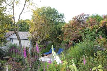 The pretty garden is behind the cottage and private for your use.