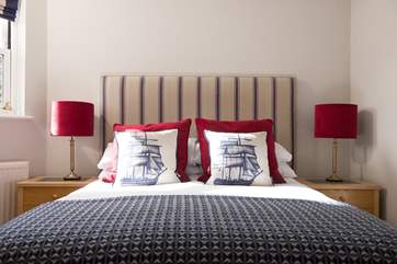 The master bedroom has al double bed with nautica influences.