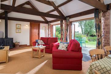The large open plan living area has two sets of French windows opening out to the patio and garden.