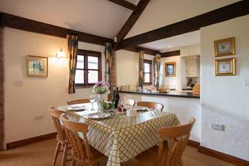 The dining-area and kitchen-area are at one end of this very spacious room.