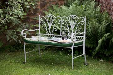 Take a book and a cup of coffee and sit by the pond at the end of the garden.