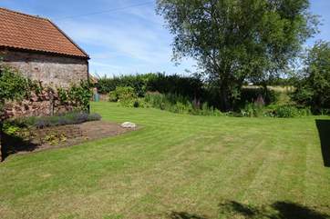 The gardens are surrounded on two sides by fields.