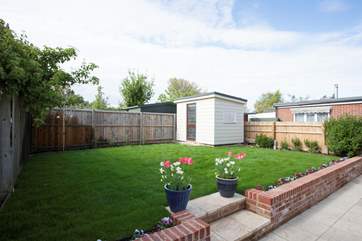 With a lawn for the children to play on and the patio for alfresco dining, the garden is a lovely additional to this family retreat