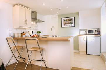 The breakfast-bar separates the kitchen from the sitting-area.