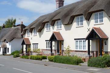 Tolpuddle is the middle cottage in the photo, the parking is behind the cottages, turn right before the white thatched cottage.