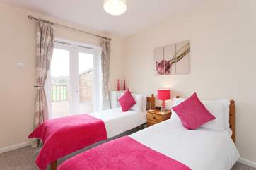 The downstairs twin bedroom has doors out to the private decking
