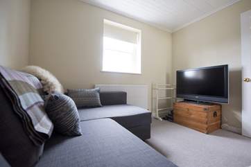 The snug has a large TV and a GameCube.