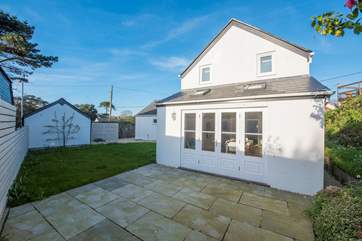 The sunny kitchen diner leads out to the enclosed patio and garden.
