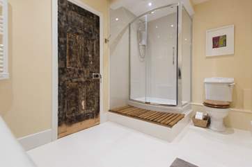 The bathroom has a large walk-in shower as well as the roll-top bath.