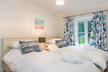 The pretty decor continues in the twin bedroom.