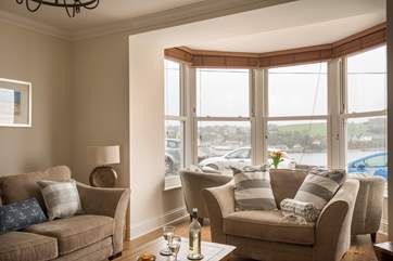 The big window floods the sitting-room with light.
