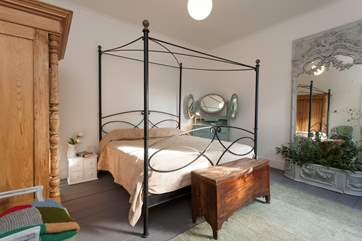 This fantastic bedroom has a four-poster, king-size bed and fantastic mirror piece all the way from France.