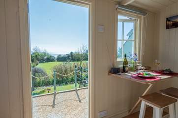 The fold-away dining-table is positioned perfectly to enjoy the fabulous views.