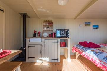 The kitchen-area has a two ring electric hob, electric rotisserie oven and very importantly an under the counter fridge with freezer
compartment.