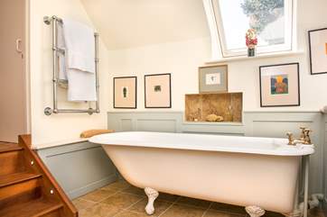 Steps lead down from the twin bedroom into the elegant en suite bathroom.