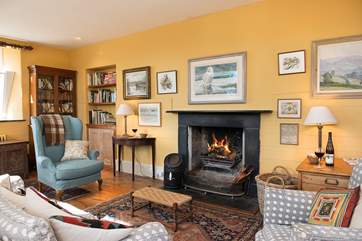Plenty of room in the sitting-room for everyone to relax in front of the open fire.