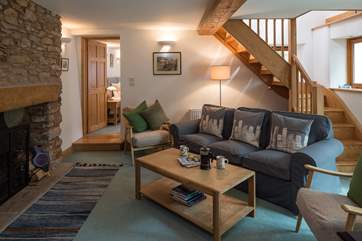 This inviting and comfortable living-area with an open fire is perfect for those cosy nights in.
