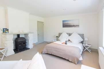 There's a wood-burner effect gas stove in this lovely ground floor bedroom.