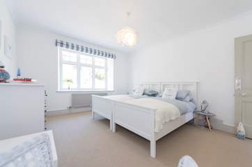 This ground floor bedroom has double or twin beds as well as luxury linens and feather pillows.