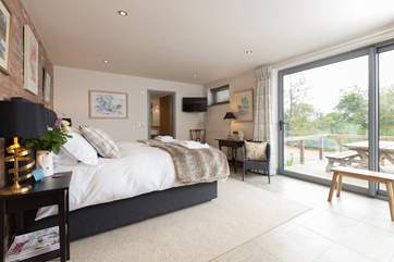 Both bedrooms are super-luxurious. This is the ground floor bedroom with access to the deck and with stunning views.