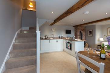 Stairs lead up to the luxurious bedroom and en-suite on the first floor