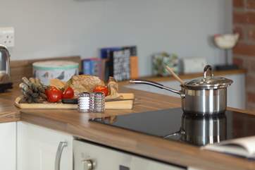 The well-equipped kitchen has an induction hob and electric oven.
