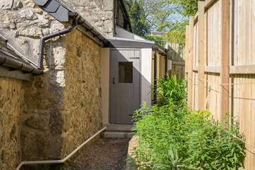 The utility-room can be accessed through the living-room or around the back of the cottage.