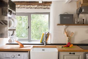 The hand-built kitchen with butler sink has views across the gardens.
