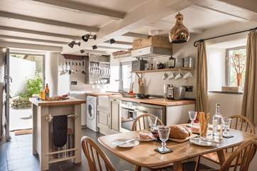 Looking back across the Ercol dining-table and chairs to the fabulous kitchen, perfect when you want to cook up a Cornish feast.