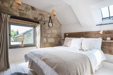 The gorgeous double bedroom with bespoke head board and views over the garden.