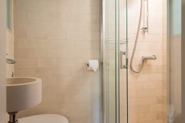 The fully tiled en suite shower-room.