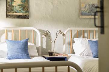 Comfortable quality mattresses top metal beds with fresh white linens.