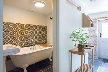 The family bathroom with gorgeous cast iron roll-top bath is on the ground floor.