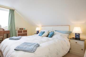 The master bedroom has delightful views across Brading Marshes.
