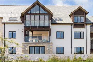The apartment is on the first floor with (in the middle of the photo with the windows open).