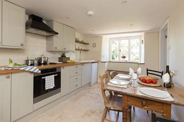 There is a newly installed kitchen with a lovely farmhouse table.