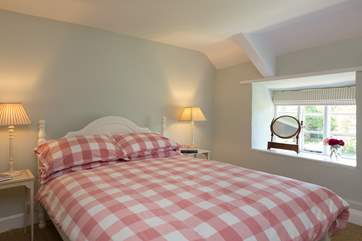 The master bedroom has a double bed and views towards the village