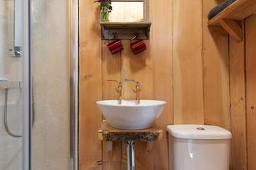 Complete with proper flushing loo and hot water.