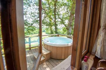 Outside the kitchen window, the bubbling hot tub sits proud on the deck.