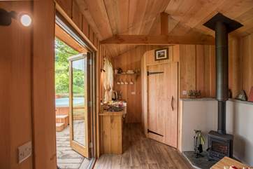 Inside the lovely open plan living-room includes a well-equipped kitchen.