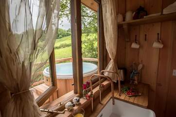 Looking through the kitchen window at the hot tub sitting proud on the deck.