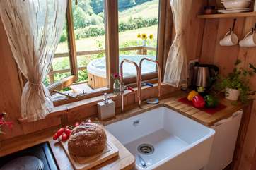 The hot tub sits just outside the cabin on the deck.