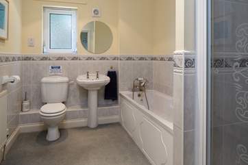Family bathroom on the first floor comprises of a bath and a shower cubicle.