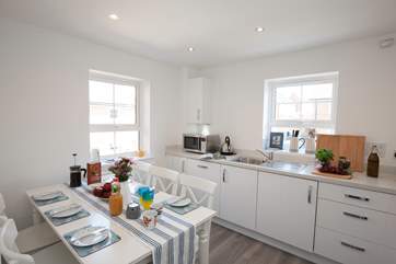 The delightful kitchen has seating for six