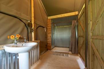 The shower-room is at the back of the tent and can be accessed from both the double and twin bedrooms.