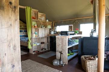 The well-equipped kitchen has a Belfast sink (with cold running water) set into a chunky wooden work surface.