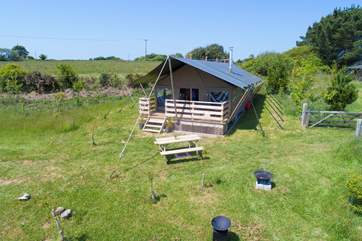 A picnic table and fire-pit BBQ are provided for al fresco cooking and dining.