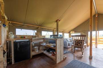 The kitchen area is equipped with all you could need for a glamping break - including a fridge, kettle and gas hob!